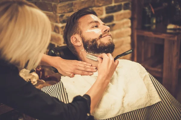 barber shaving mans neck