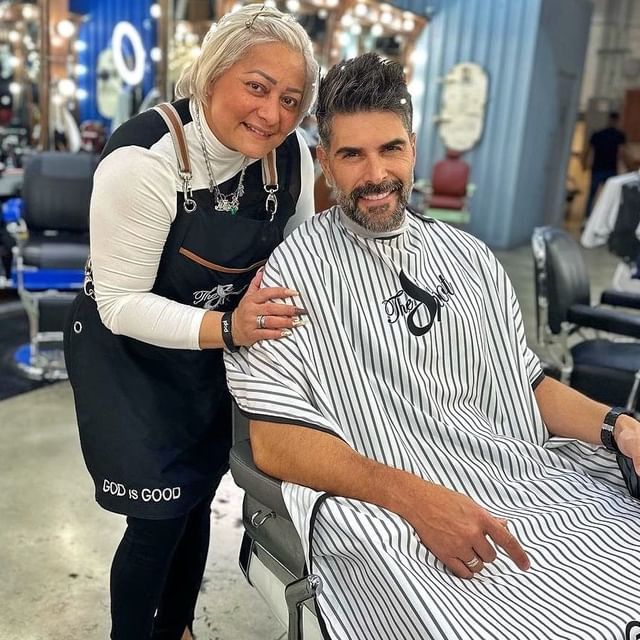 barber taking photos with a client