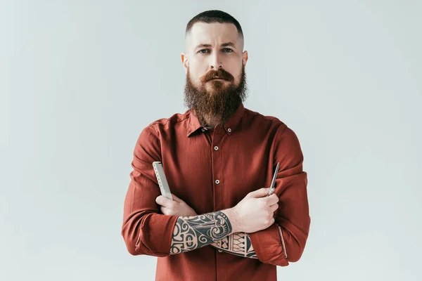 barber with beard holding tools