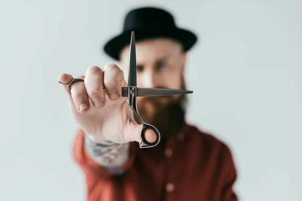 man holding a scissor close up