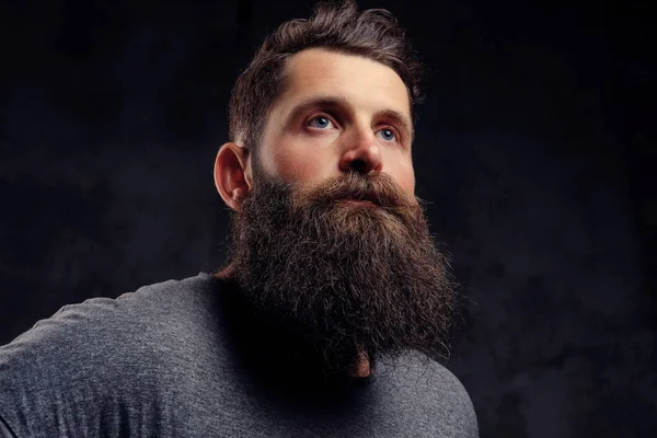 man with long beard staring above