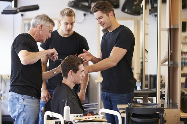 master barber teaching his apprentice