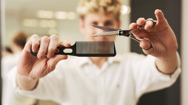 Professional Hair Stylist Holding Scissors And Comb In Beauty Salon.